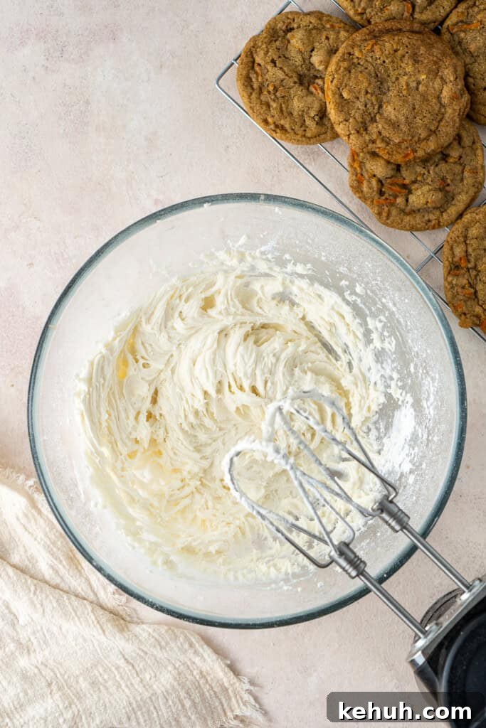Making the buttercream in a bowl with a mixer.