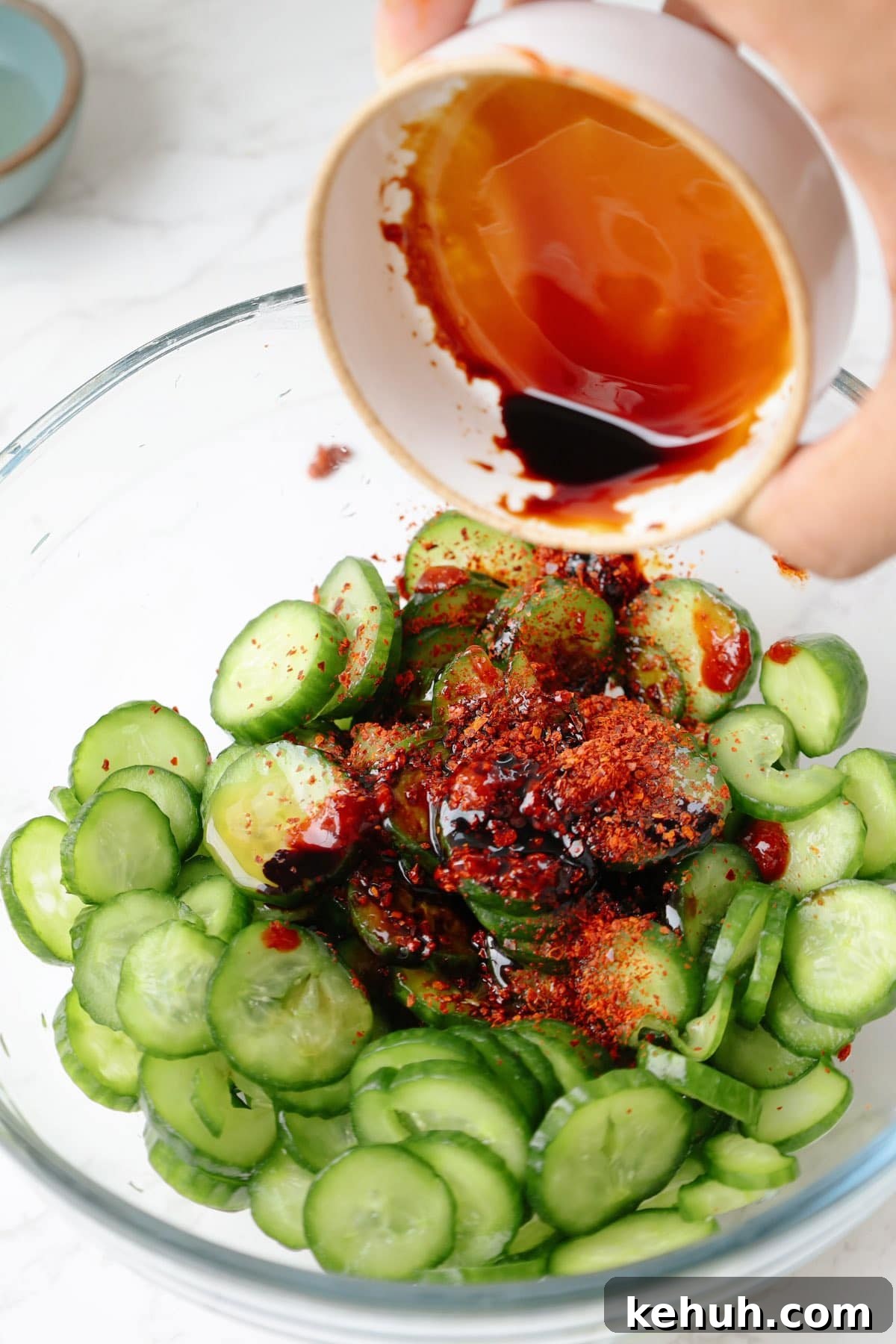 Step two: add the sauces to the cucumbers.