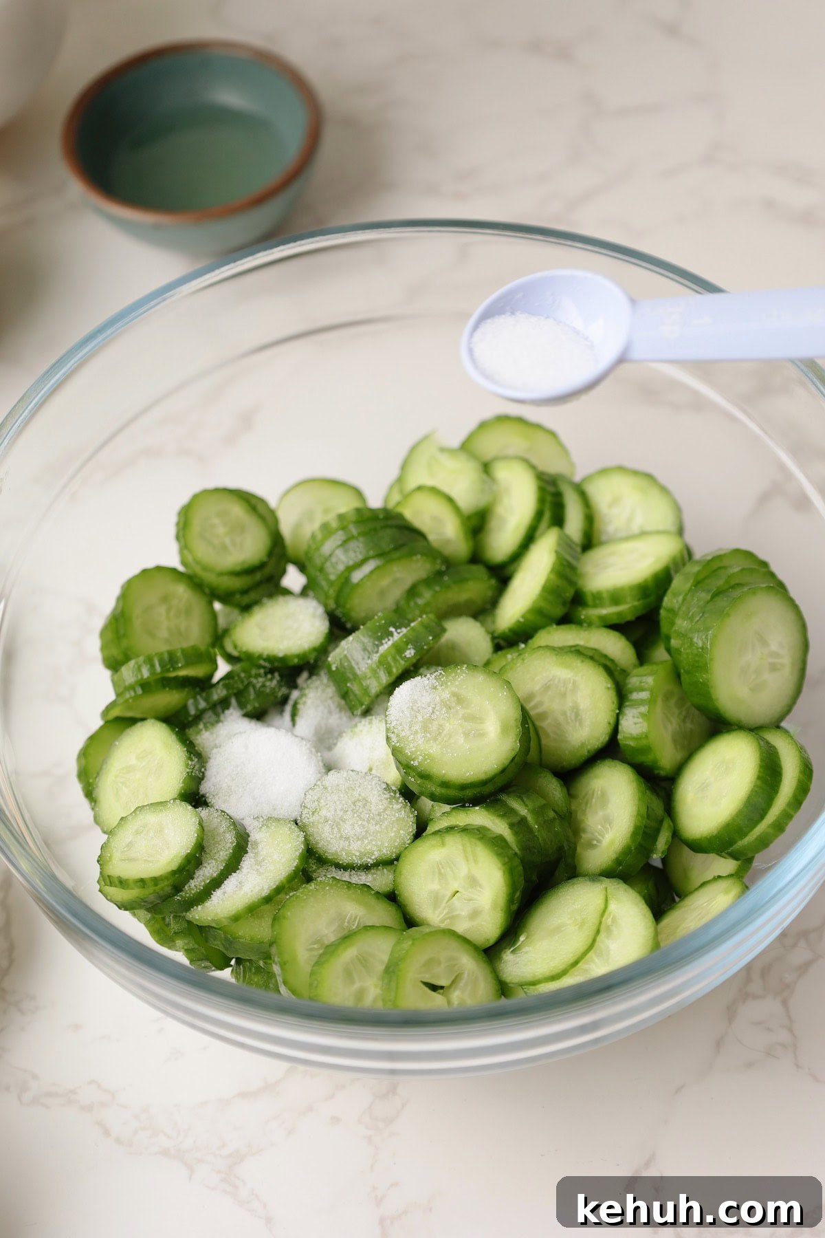 Salt the cucumbers for the Korean cucumber salad.