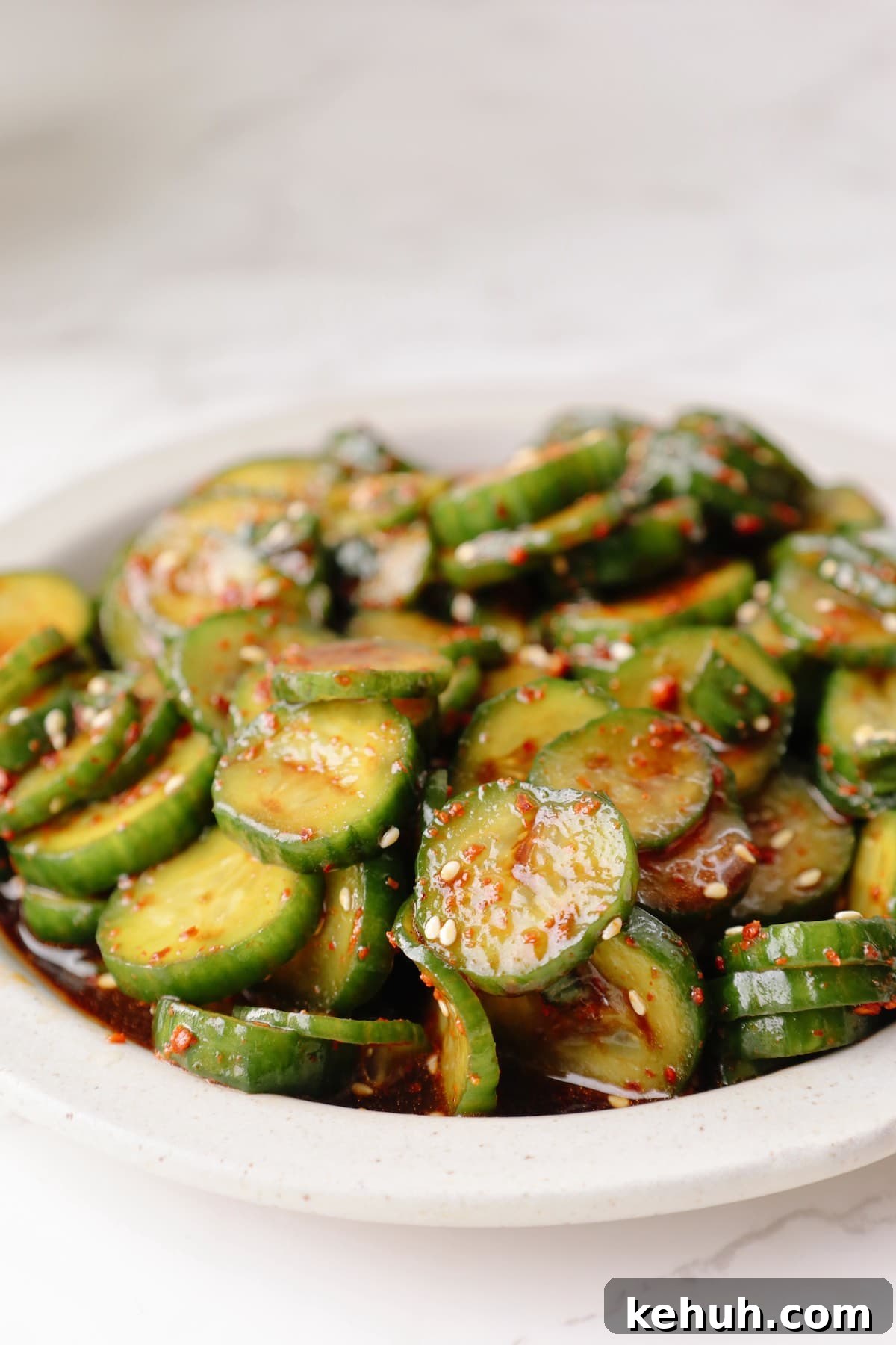 Korean cucumber salad on a white plate.