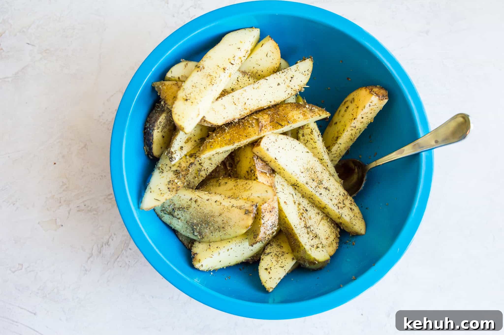 Seasoned potato wedges in a bowl. 