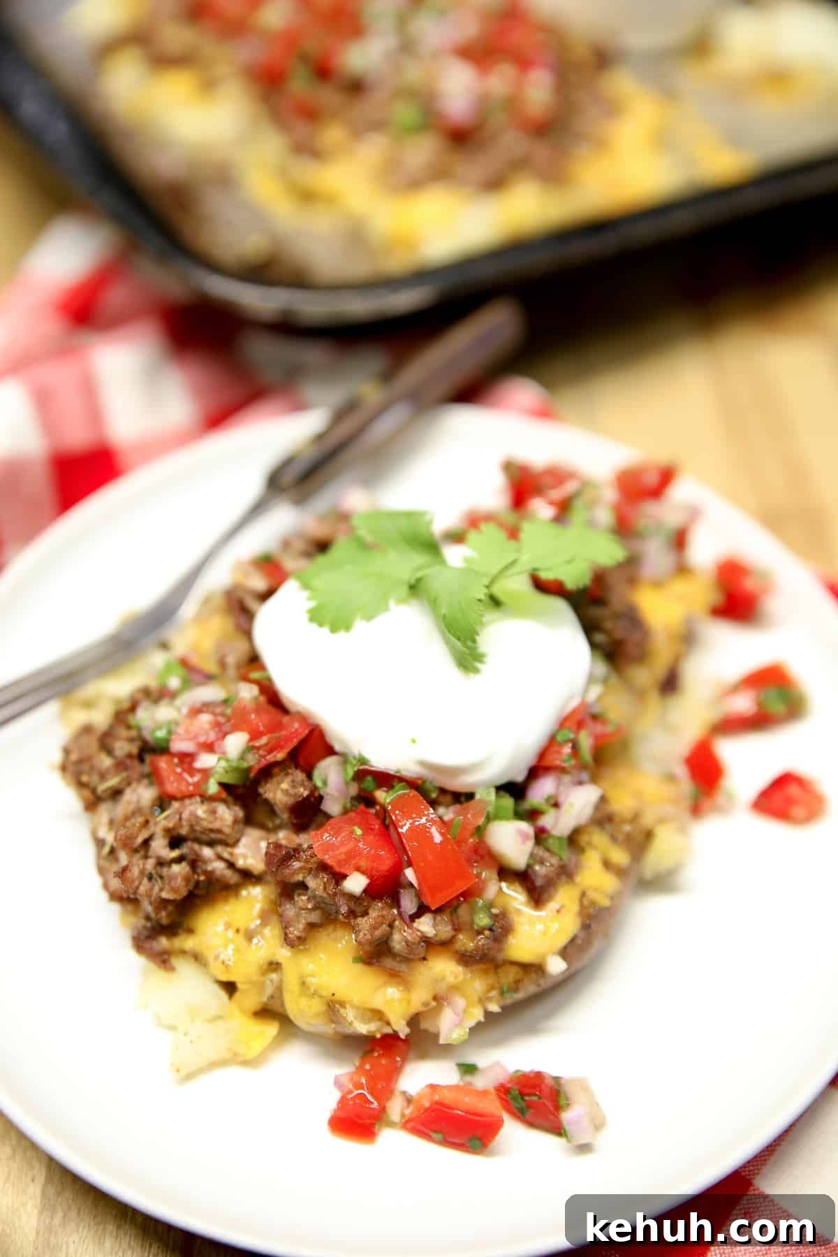 Loaded smashed potatoes with salsa fresca and sour cream.