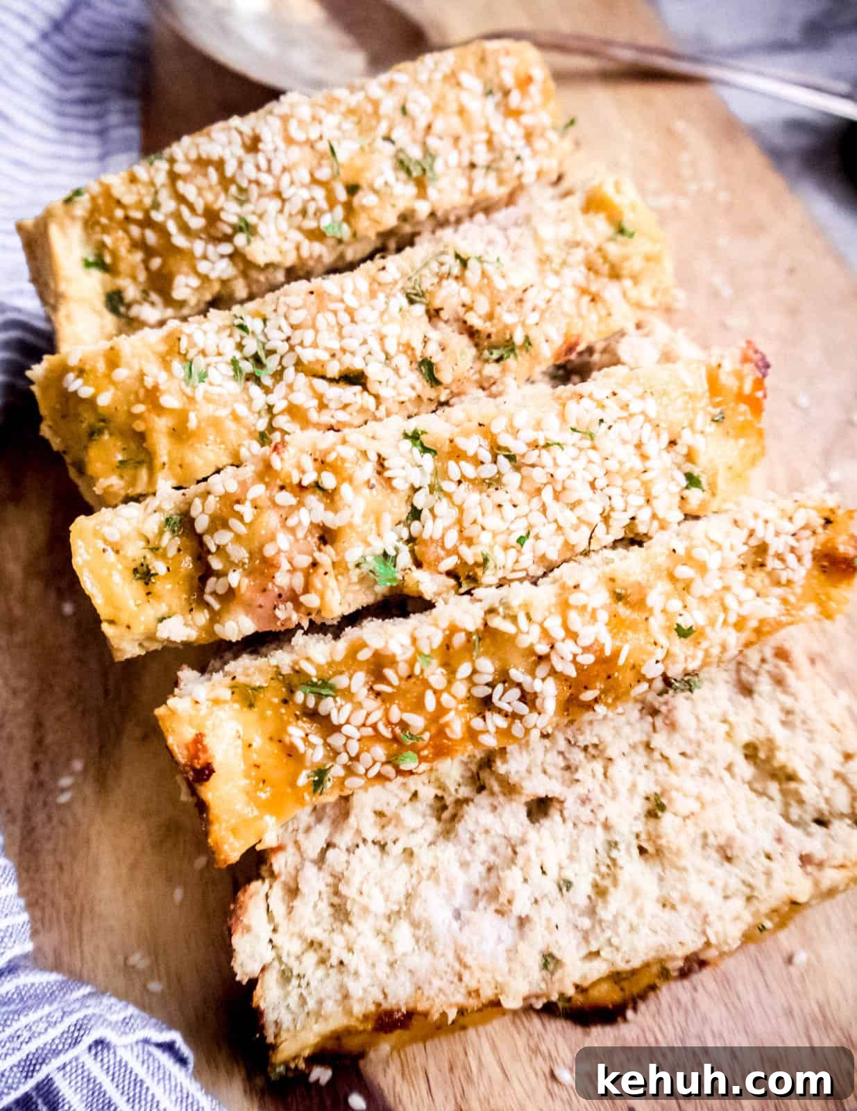 Honey Sesame Paleo Turkey Meatloaf Recipe for Low-Carb Dinners 5 Sliced honey sesame paleo meatloaf on a cutting board.