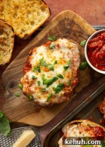 Chicken Parmesan Sandwich overhead shot of open chicken parmesan sandwich on wooden board