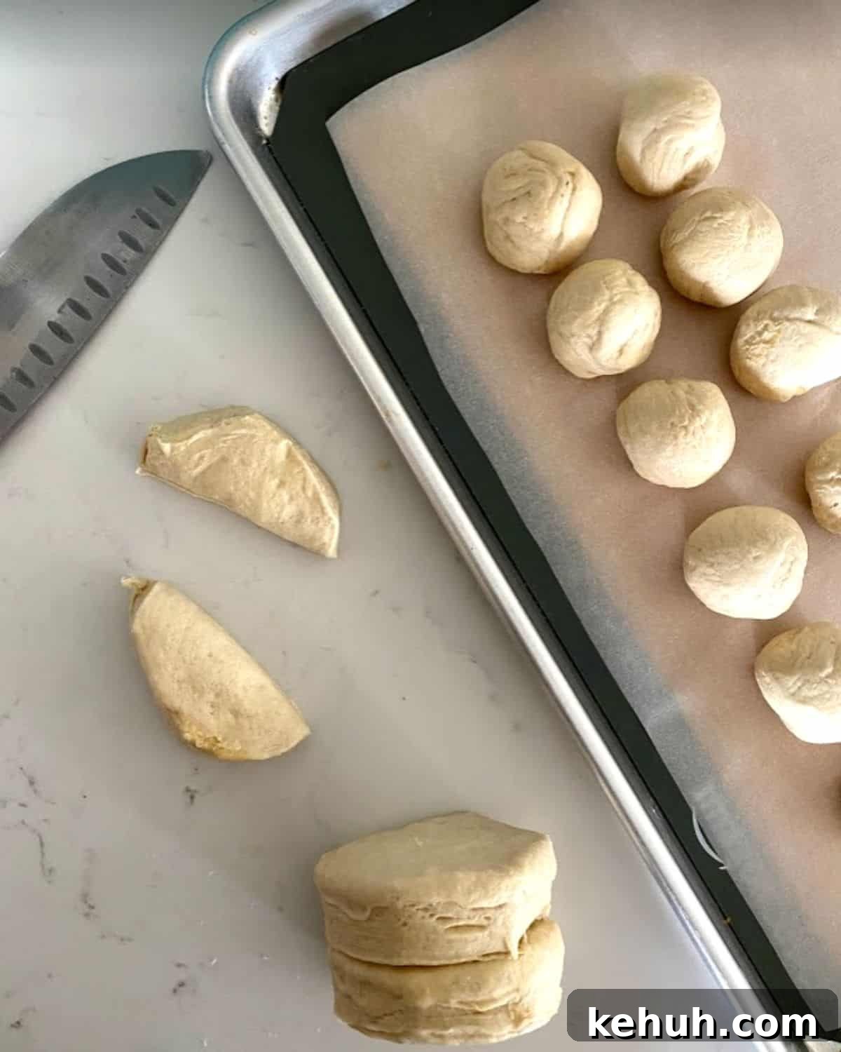 Biscuit dough in half rolled into balls.