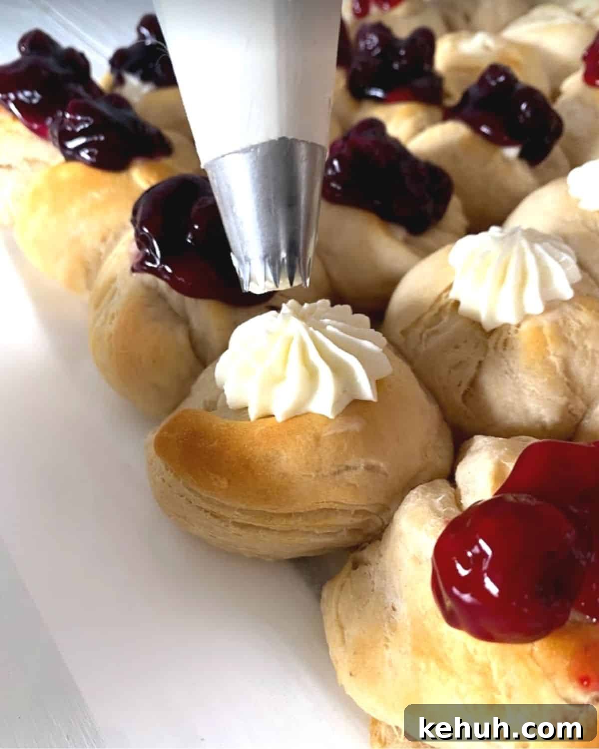 Piping cheesecake filling into flag dessert biscuits.