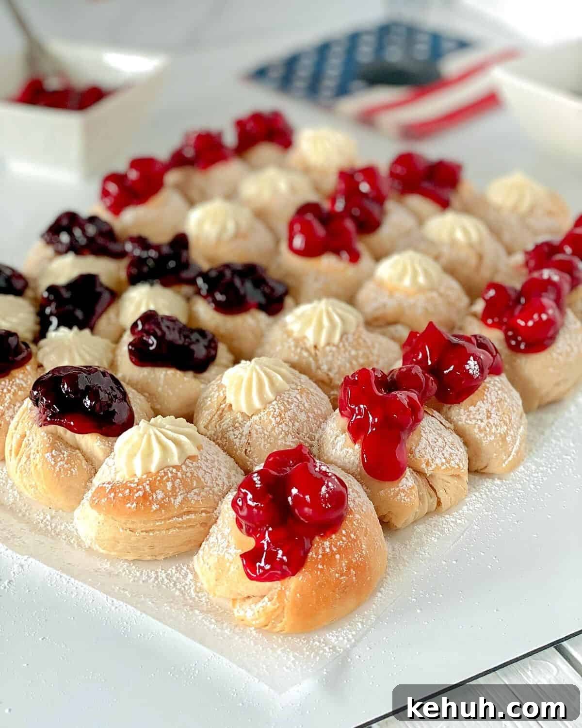 Red white and blue flag biscuits on a table topped with pie filling.