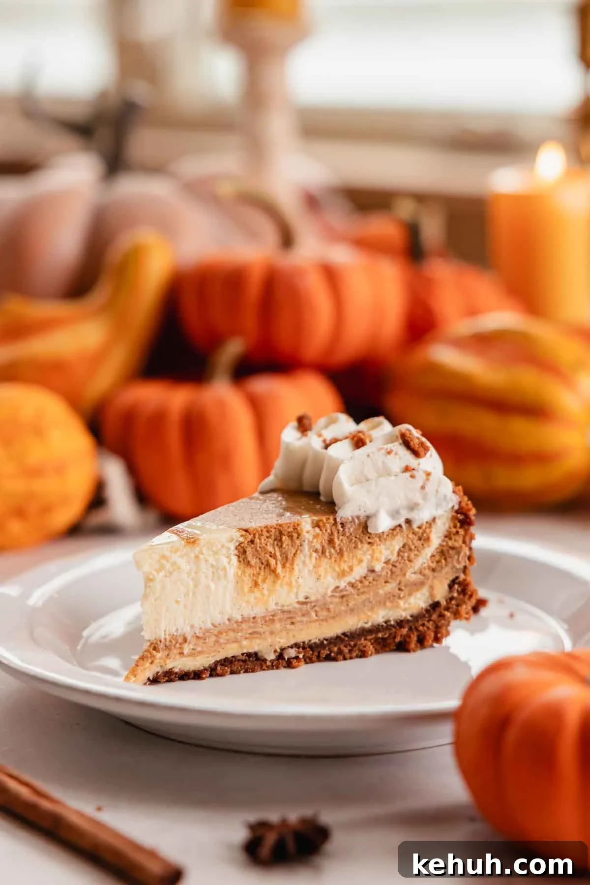 Pumpkin Swirl Cheesecake Recipe: Creamy Autumn Dessert 6 slice of pumpkin pie cheesecake on a plate with whipped cream