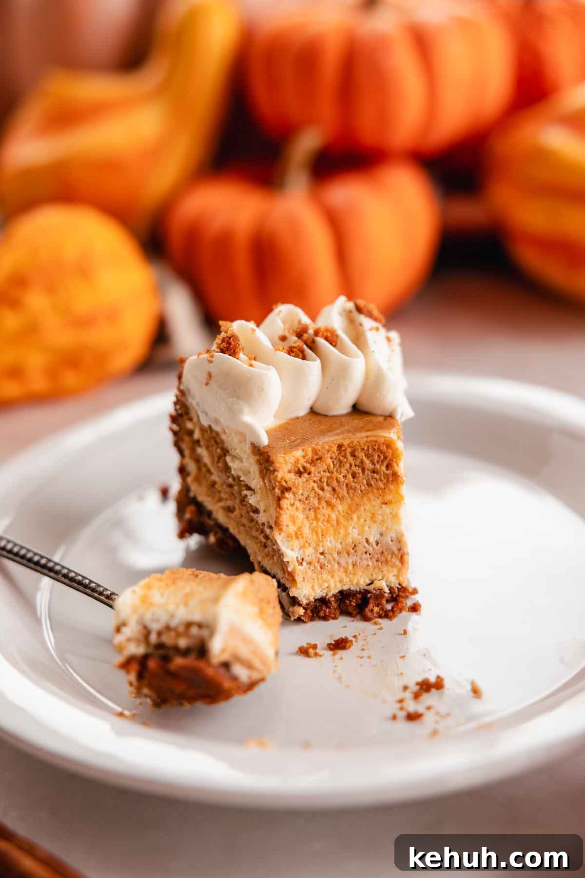 Pumpkin Swirl Cheesecake Recipe: Creamy Autumn Dessert 3 slice of pumpkin pie cheesecake on a plate
