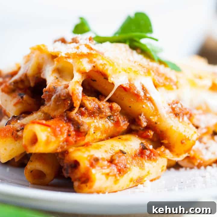 Scoop of baked ziti on a plate.