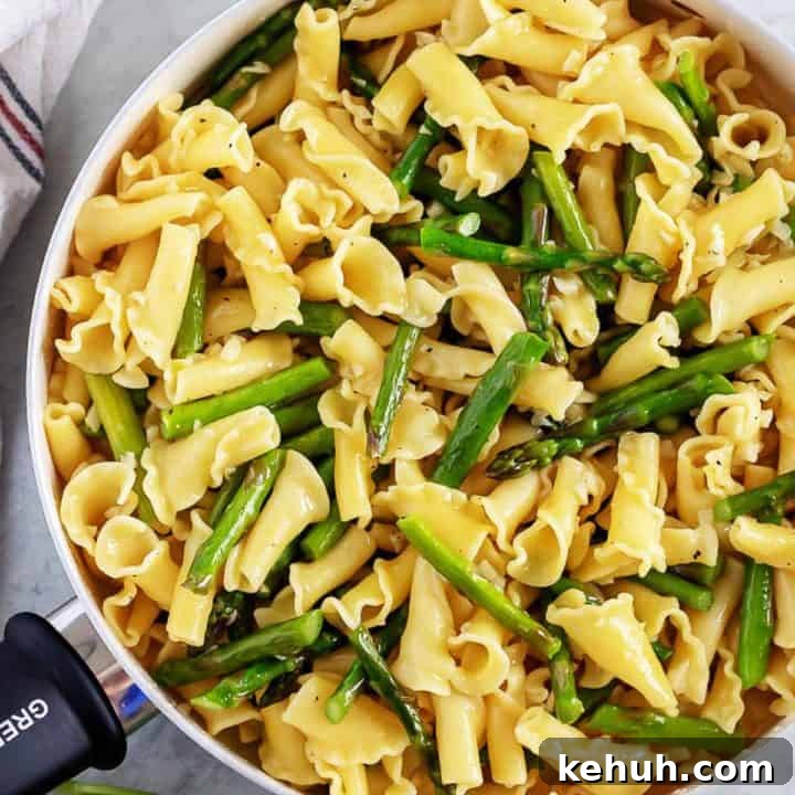 Top down view of a pan of garlic asparagus pasta.