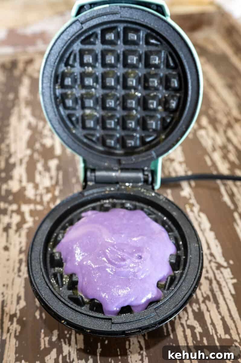 Ube Waffles Recipe: Crispy Purple Filipino Waffles 8 Ube waffle batter on waffle maker.
