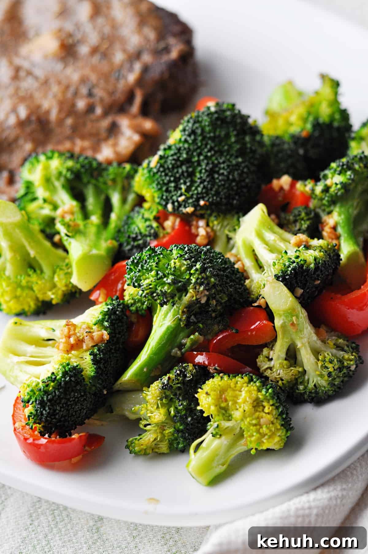 Sautéed Broccoli with Red Bell Pepper Recipe for Quick Sides 2 Cooked broccoli and red pepper on plate ready to eat.