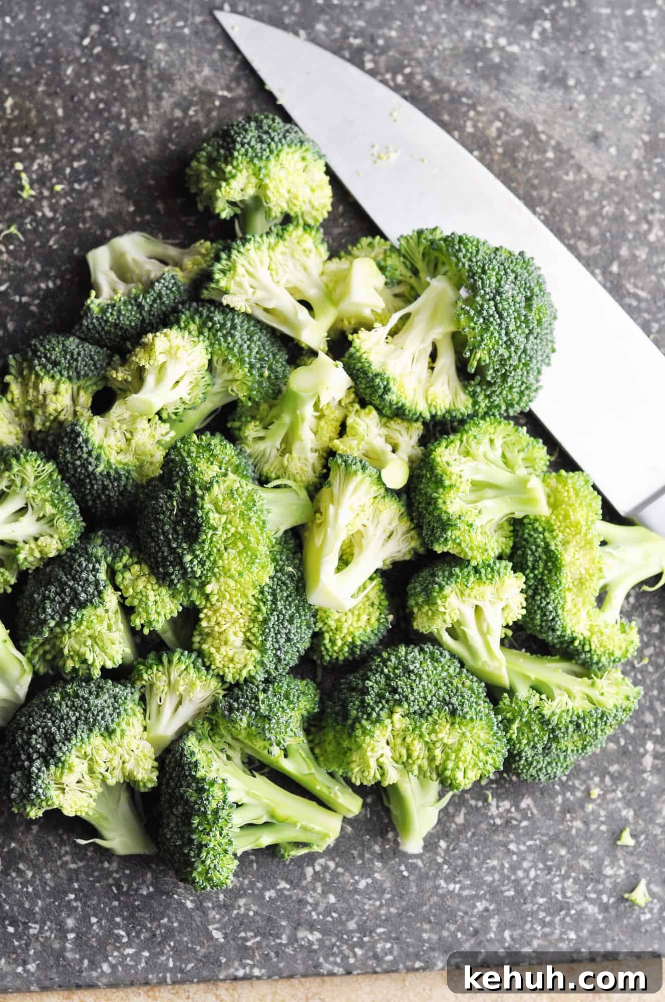 Sautéed Broccoli with Red Bell Pepper Recipe for Quick Sides 4 Chopped raw broccoli on cutting board with knife.