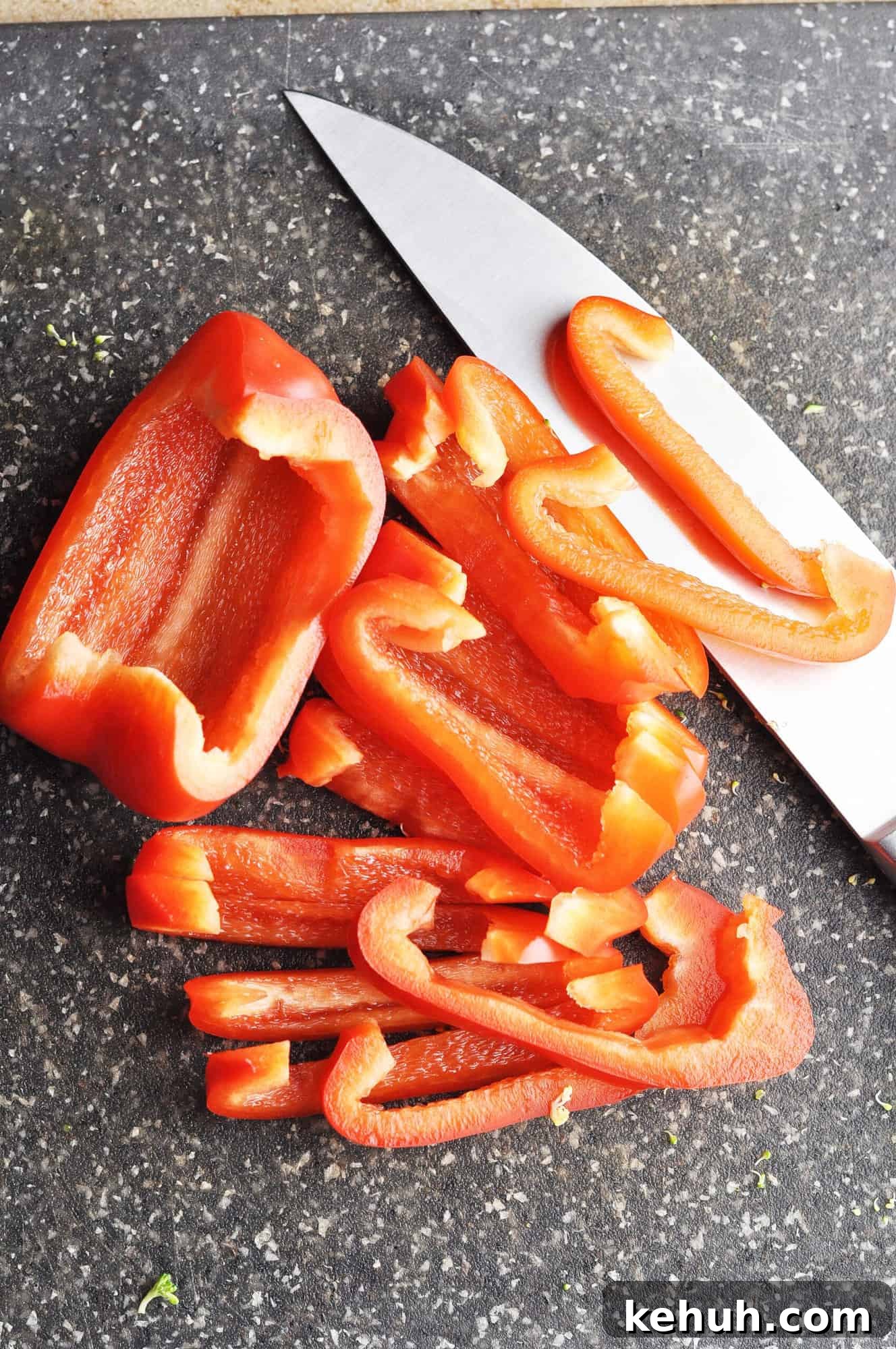 Sautéed Broccoli with Red Bell Pepper Recipe for Quick Sides 5 Sliced red bell pepper on cutting board with knife.