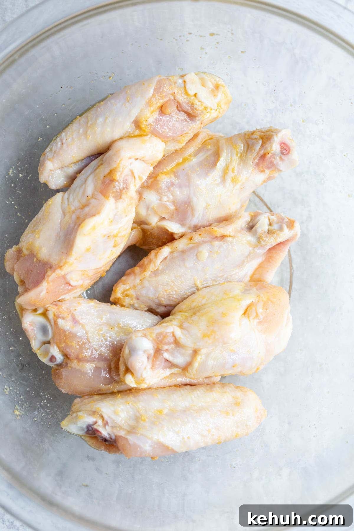 Raw chicken wings in a bowl.