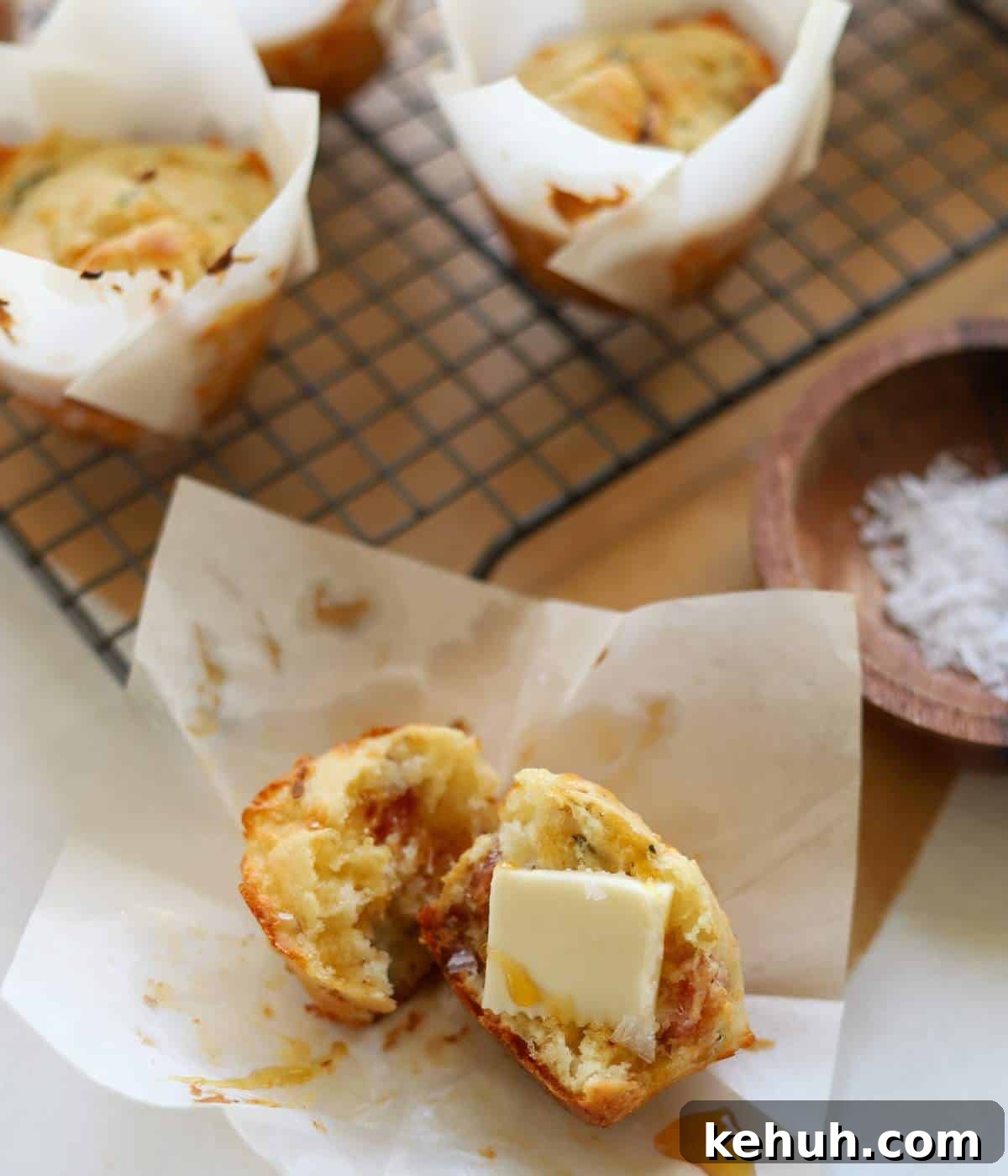 Cheesy Bacon Muffins: Savory Breakfast & Snack Recipe 2 Bacon cheddar muffins with butter and honey.