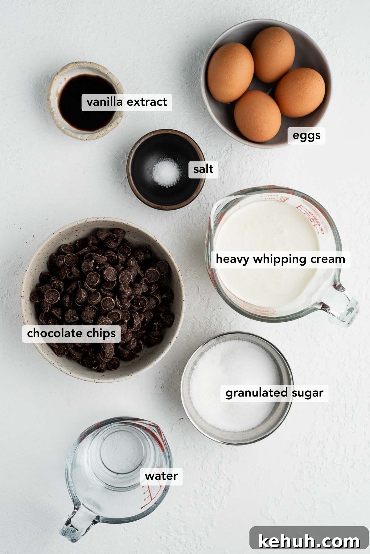 Ingredients needed to make easy blender chocolate mousse on white textured background.
