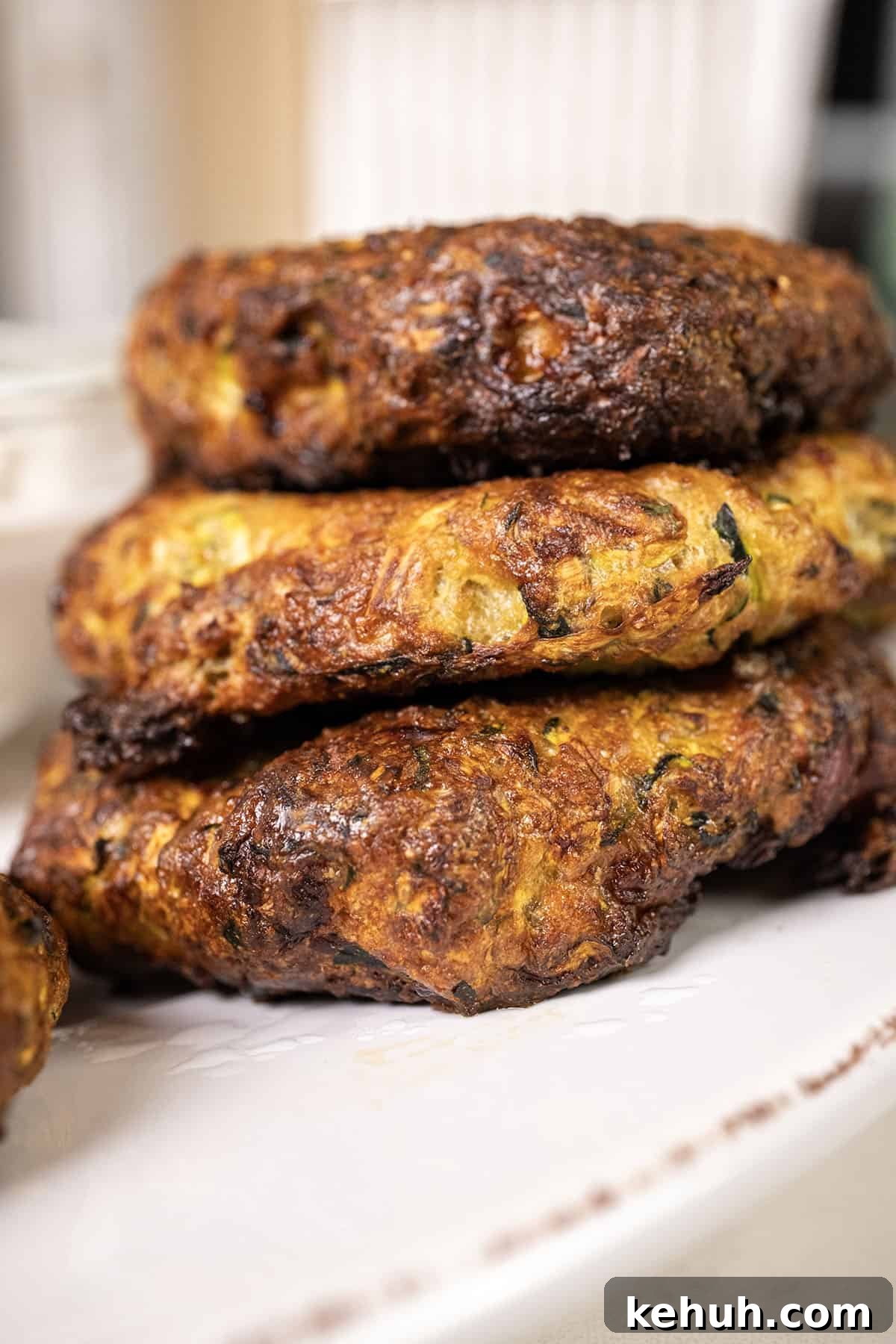 Crispy Air Fryer Zucchini Fritters Recipe 10 Zucchini fritters on a plate.