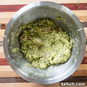 Crispy Air Fryer Zucchini Fritters Recipe 7 All ingredients mixed together in a bowl.