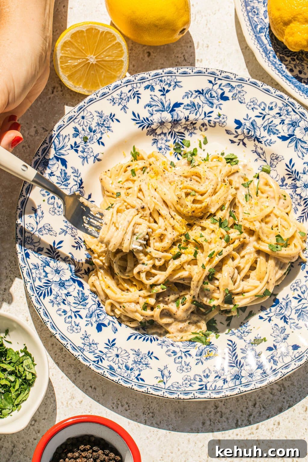 a large bowl of lemon pasta with some of it twirled on a fork 