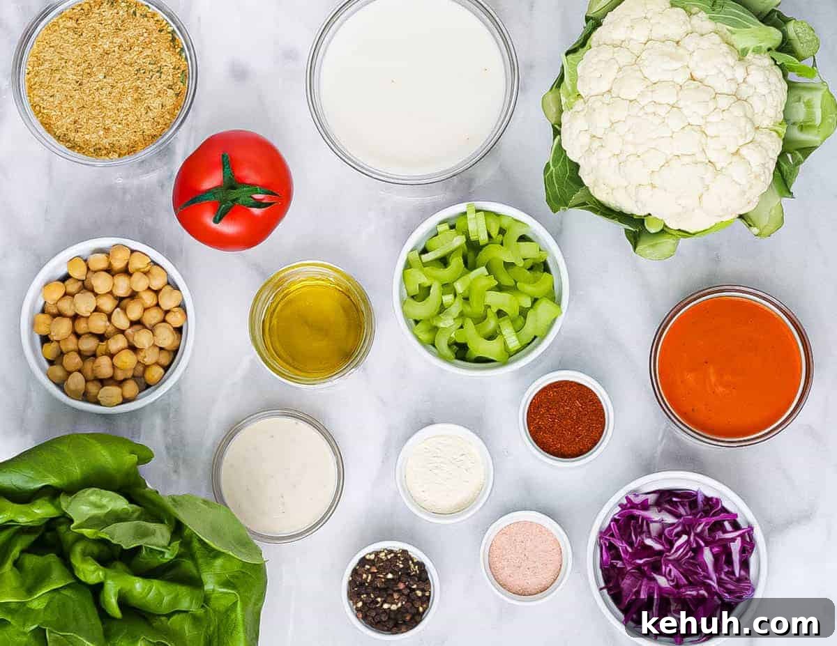 Spicy Buffalo Cauliflower Salad with Crisp Greens and Ranch Drizzle 3 Salad ingredients laid out in circular bowls.