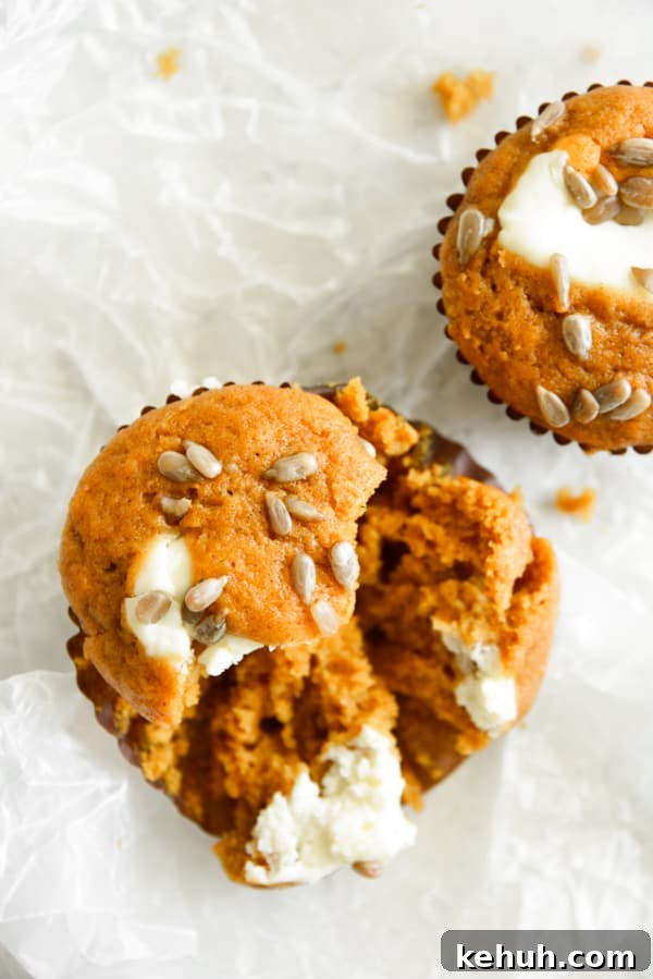 Pumpkin Cream Cheese Muffins broken in half. 