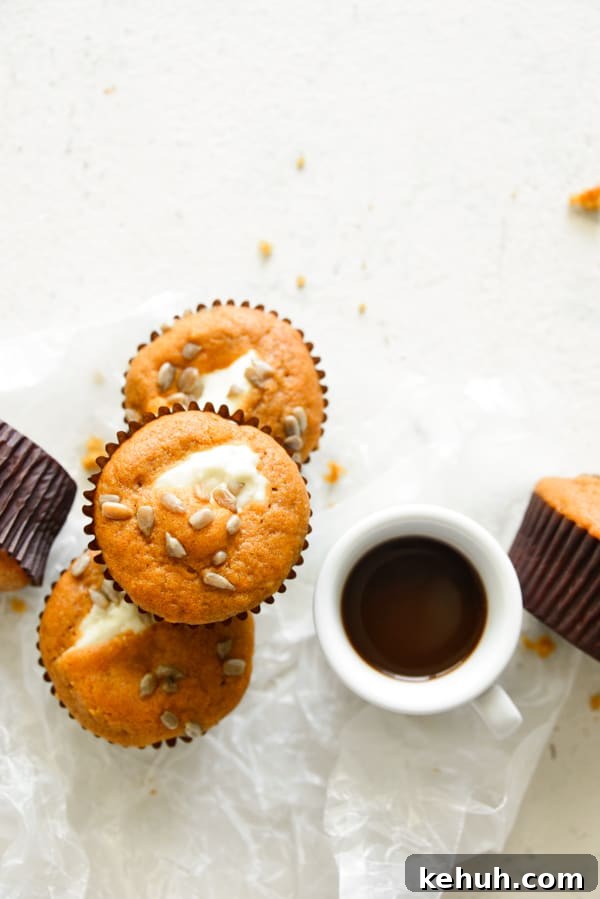 Pumpkin Cream Cheese Muffins served with a cup of coffee.