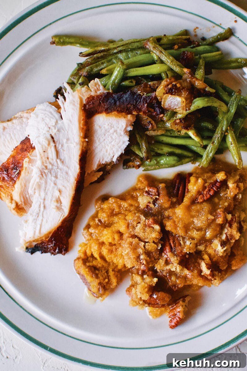 Great-Aunt Sally’s Classic Sweet Potato Soufflé Recipe 14 Great Aunt Sally's Sweet Potato Soufflé on a plate with Thanksgiving turkey and green beans.