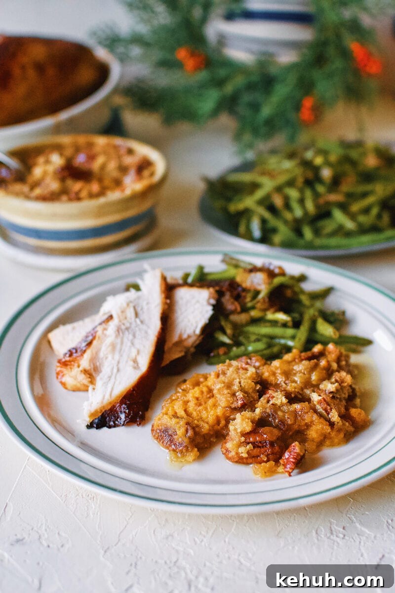 Great-Aunt Sally’s Classic Sweet Potato Soufflé Recipe 15 Great Aunt Sally's Sweet Potato Soufflé on a plate with Thanksgiving turkey and green beans.