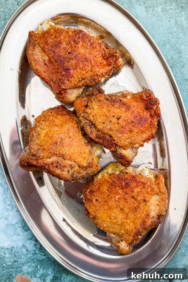 Pan-Roasted Chicken with Caramelized Cabbage | Whole30 Paleo 3 seared chicken thighs in a tray