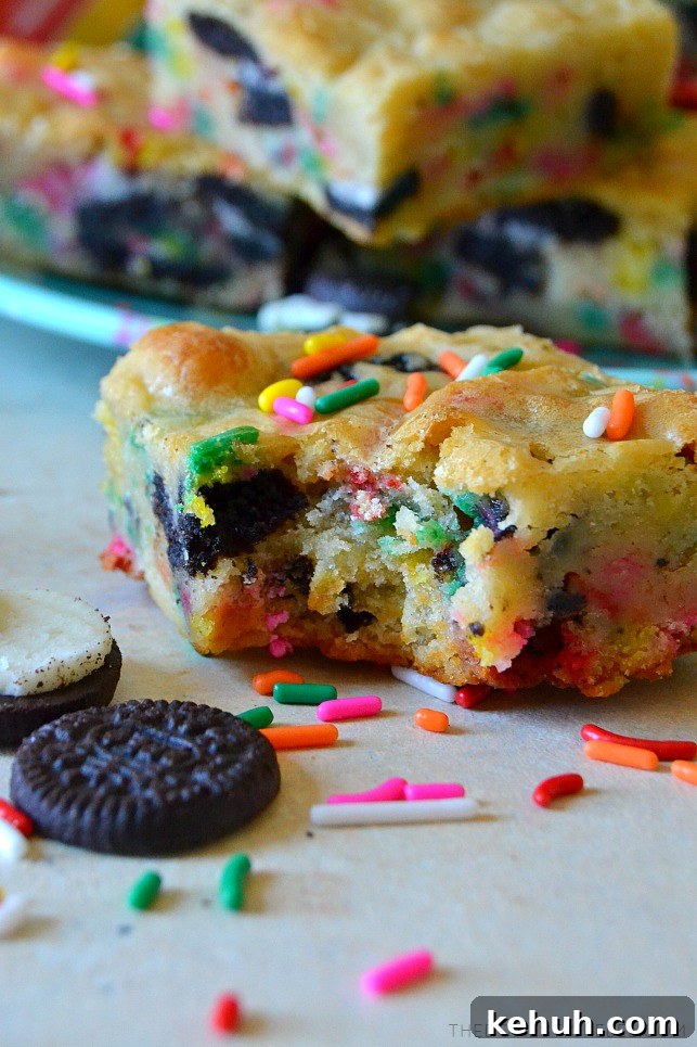 Cookies and Cream Cake-Batter Blondies: Decadent No-Fuss Treat 8 Cookies & cream cake batter blondie with bite missing and sprinkles
