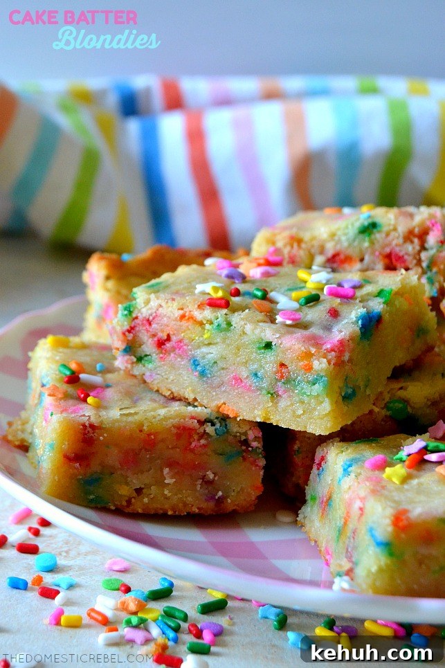 Cookies and Cream Cake-Batter Blondies: Decadent No-Fuss Treat 10 cake batter blondies stacked on pink plate with sprinkles