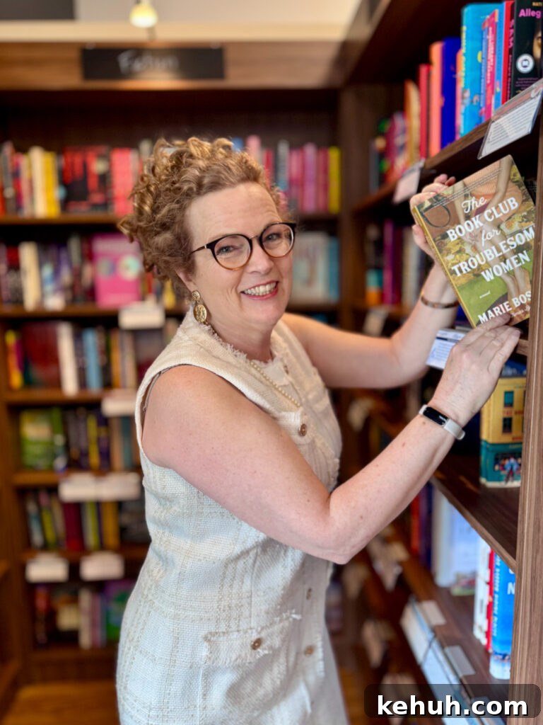 Marie pulling a copy of The Book Club for Troublesome Women 