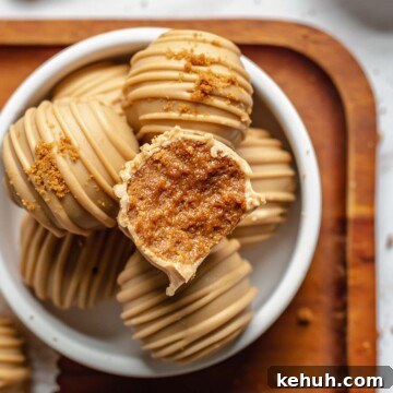A bite removed from a biscoff truffle.