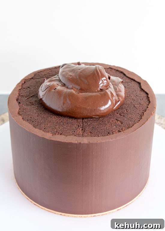 How to Cover a Cake with Smooth Ganache Finish 12 A large blob of ganache on the top of the cake.