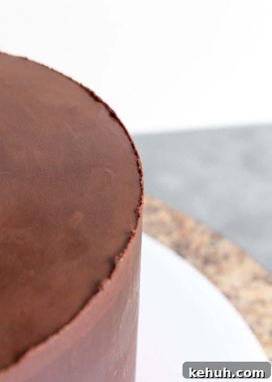 How to Cover a Cake with Smooth Ganache Finish 14 Warm up your scraper and scrape once more around the sides of the cake.