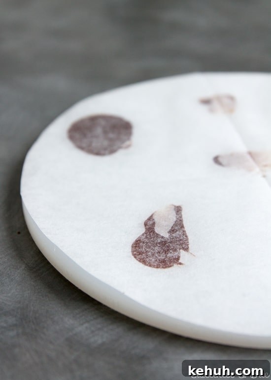 How to Cover a Cake with Smooth Ganache Finish 6 White acrylic ganache 'lid' covered in baking paper.