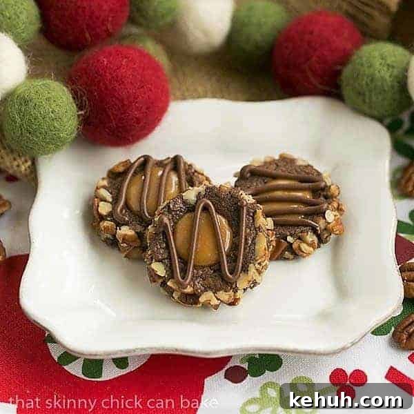 Turtle Thumbprint Cookies - chocolate thumbprints rolled in pecans and filled with caramel! Turtle Thumbprint Cookies on a square white plate.