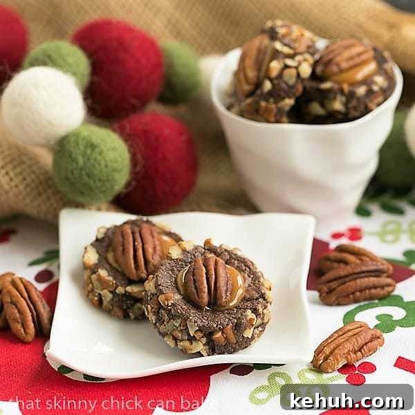 Turtle Thumbprint Cookies - chocolate thumbprints rolled in pecans and filled with caramel! Thumprint Cookie Recipe on a small white ceramic plate with a small bowl of cookies.