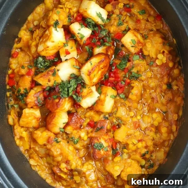 A finished Slow Cooker Dahl recipe topped with paneer and coriander.