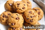 large pumpkin chocolate chip cookies on a white plate