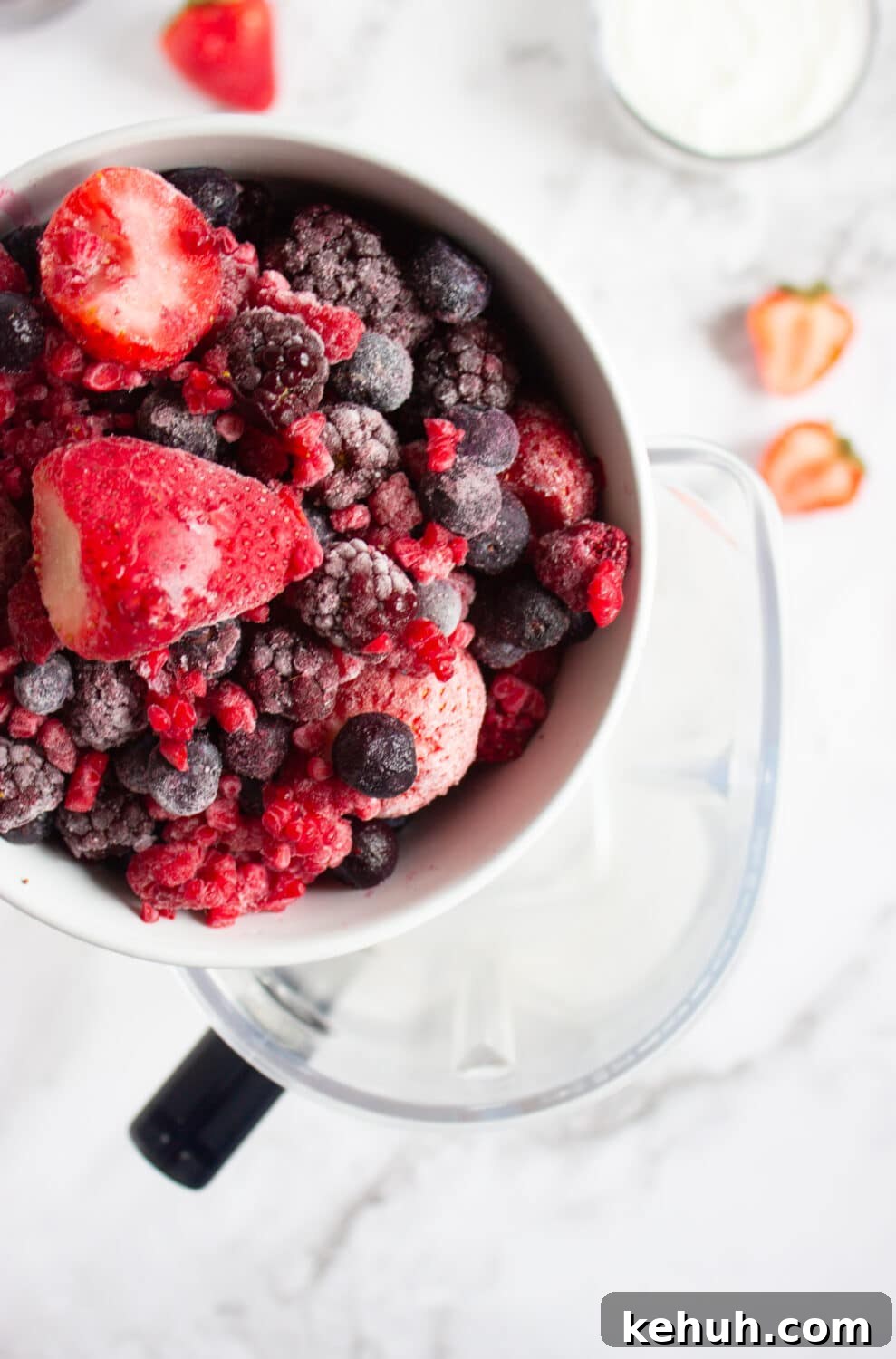 adding berries to a blender