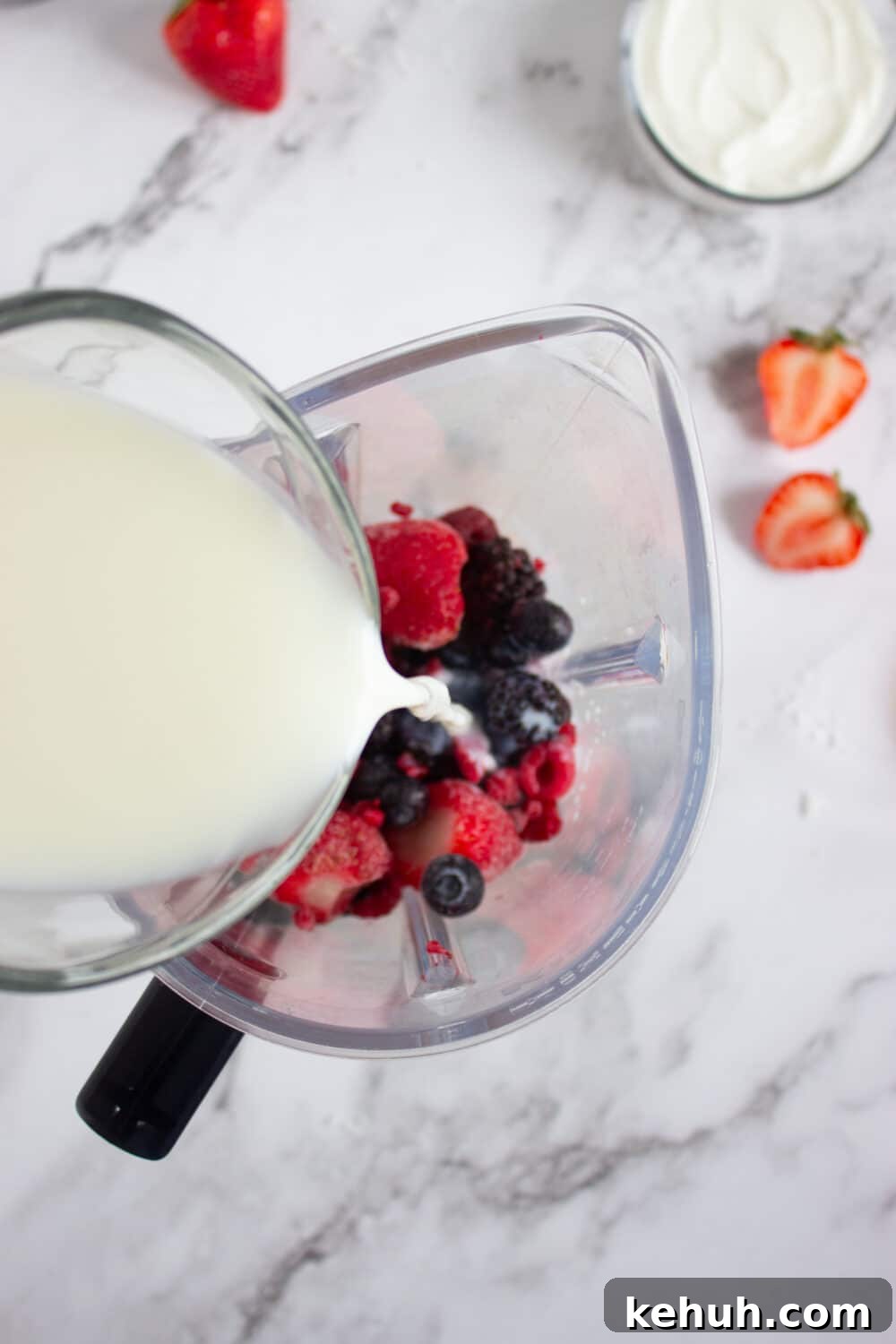 adding milk to a blender