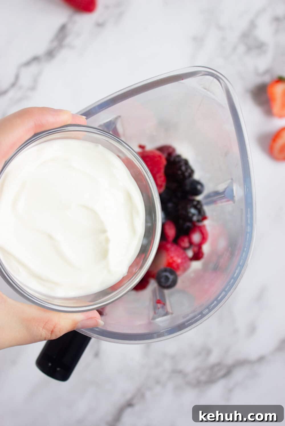 adding Greek yogurt to a blender