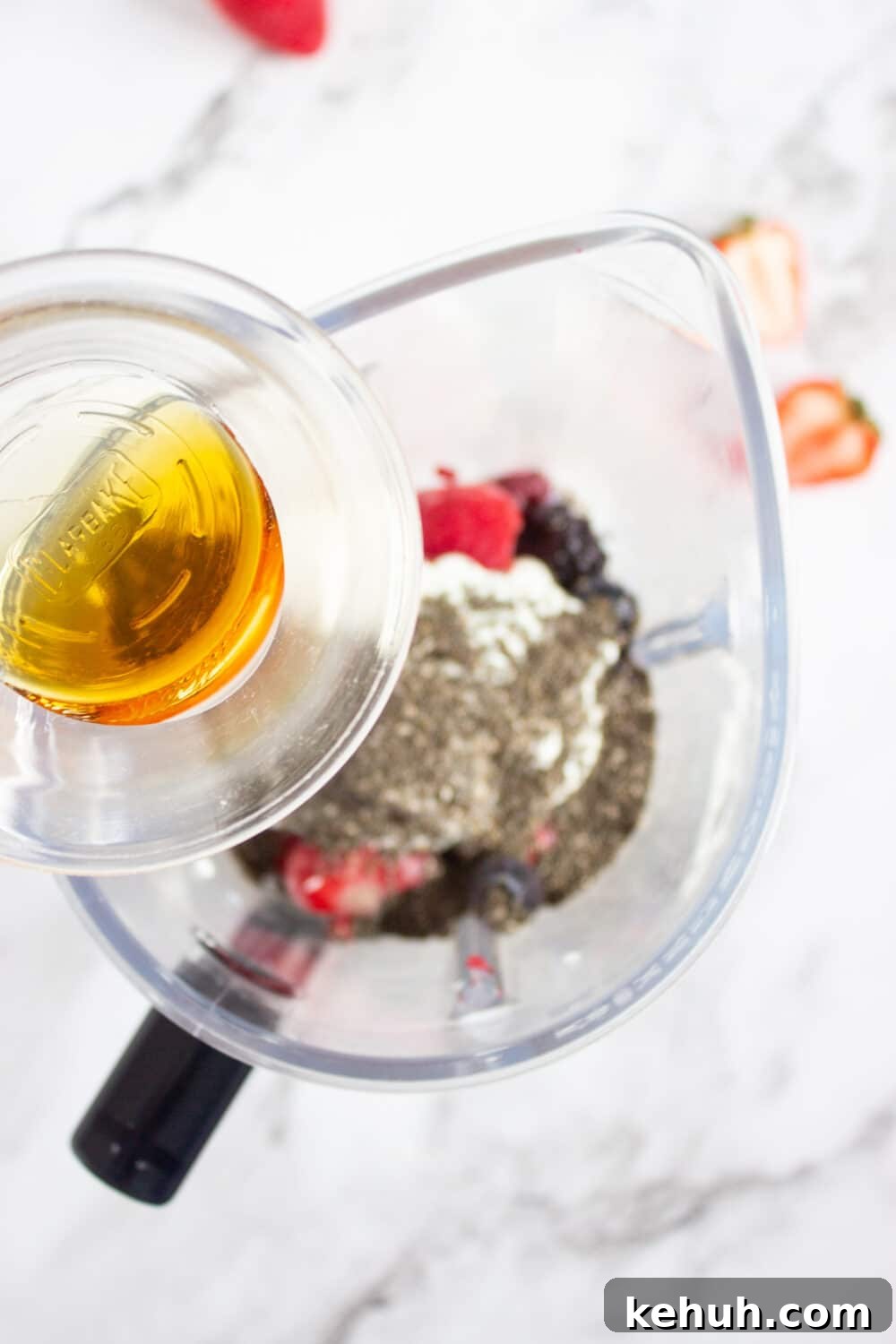 adding maple syrup to a blender