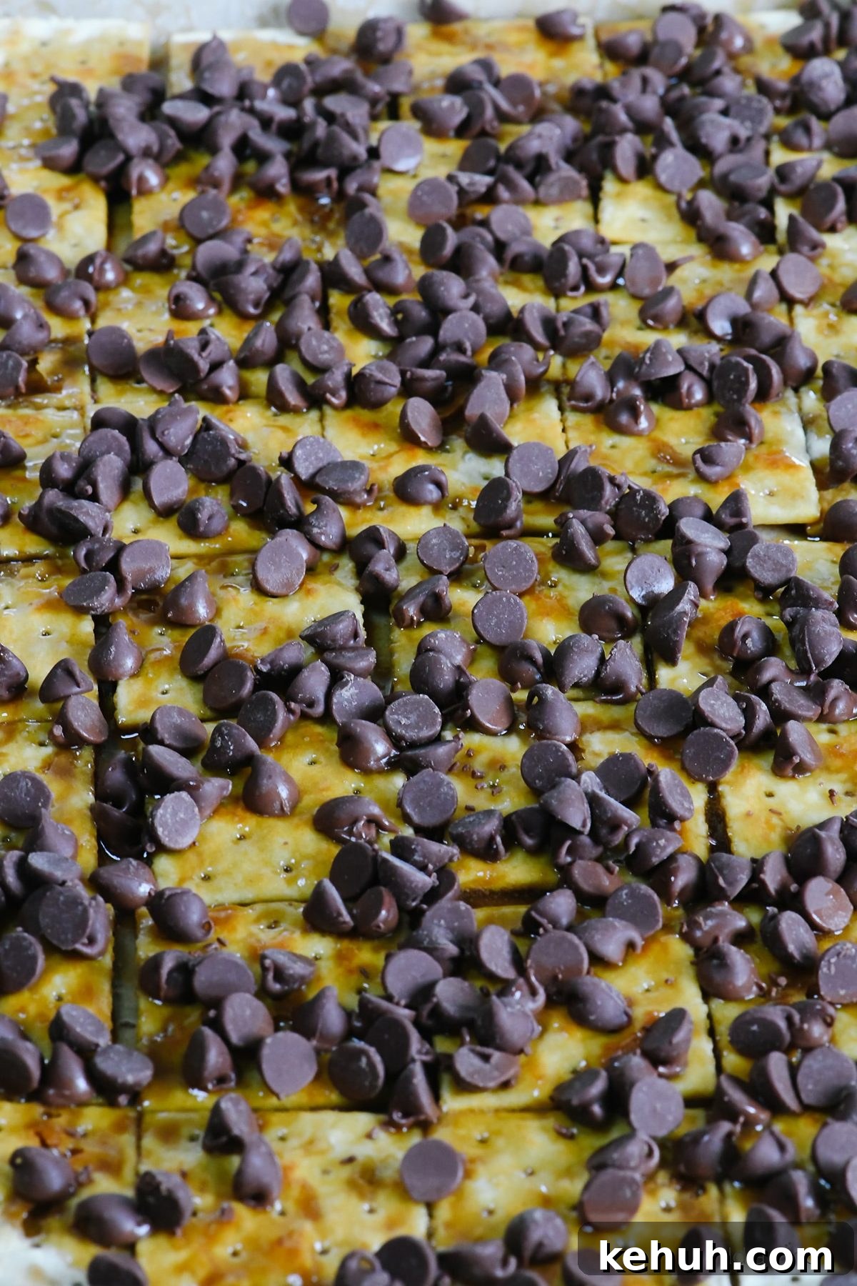 Classic Cracker Toffee Recipe with Crunchy Caramel Topping 7 Chocolate chips cover saltines that have been topped with caramel.
