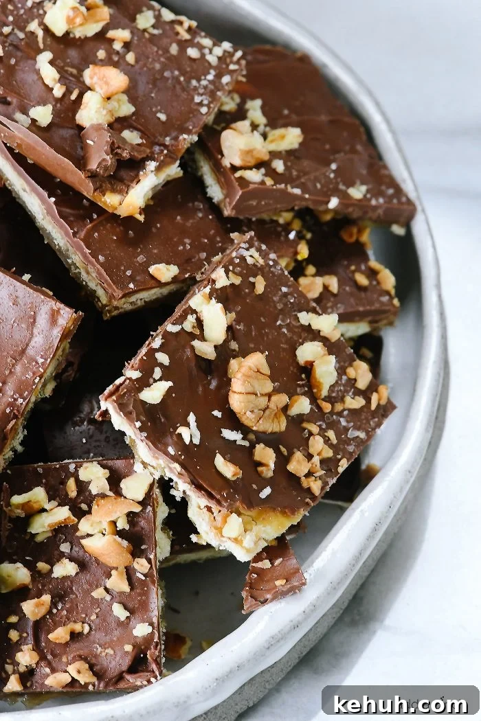 Classic Cracker Toffee Recipe with Crunchy Caramel Topping 10 Platter of nut-covered saltine cracker toffee.