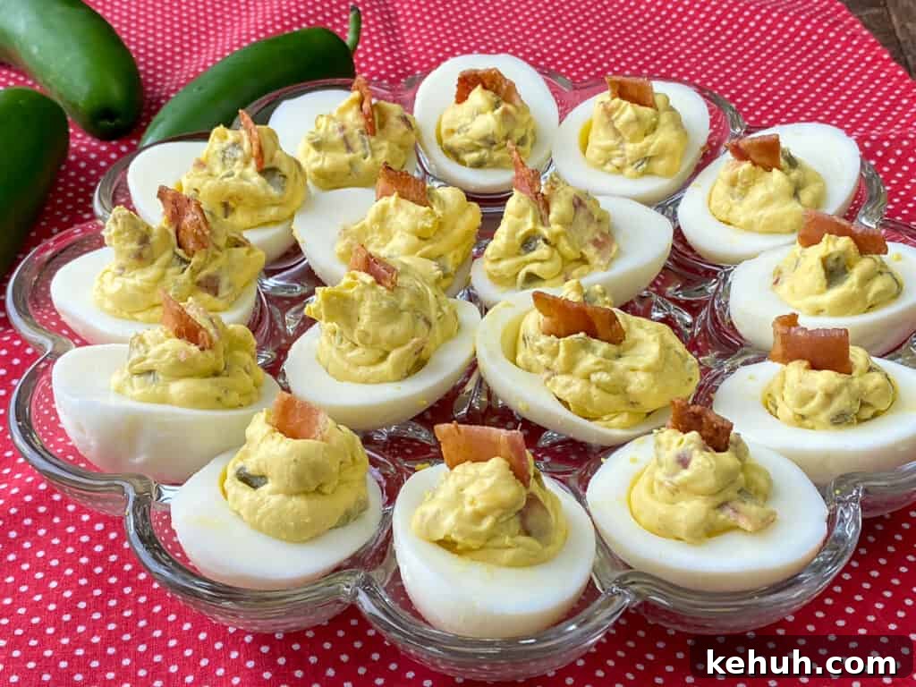 Bacon Jalapeño Deviled Eggs Recipe – Spicy Stuffed Egg Bites 2 Chunk of bacon garnishing deviled eggs with bacon and jalapenos