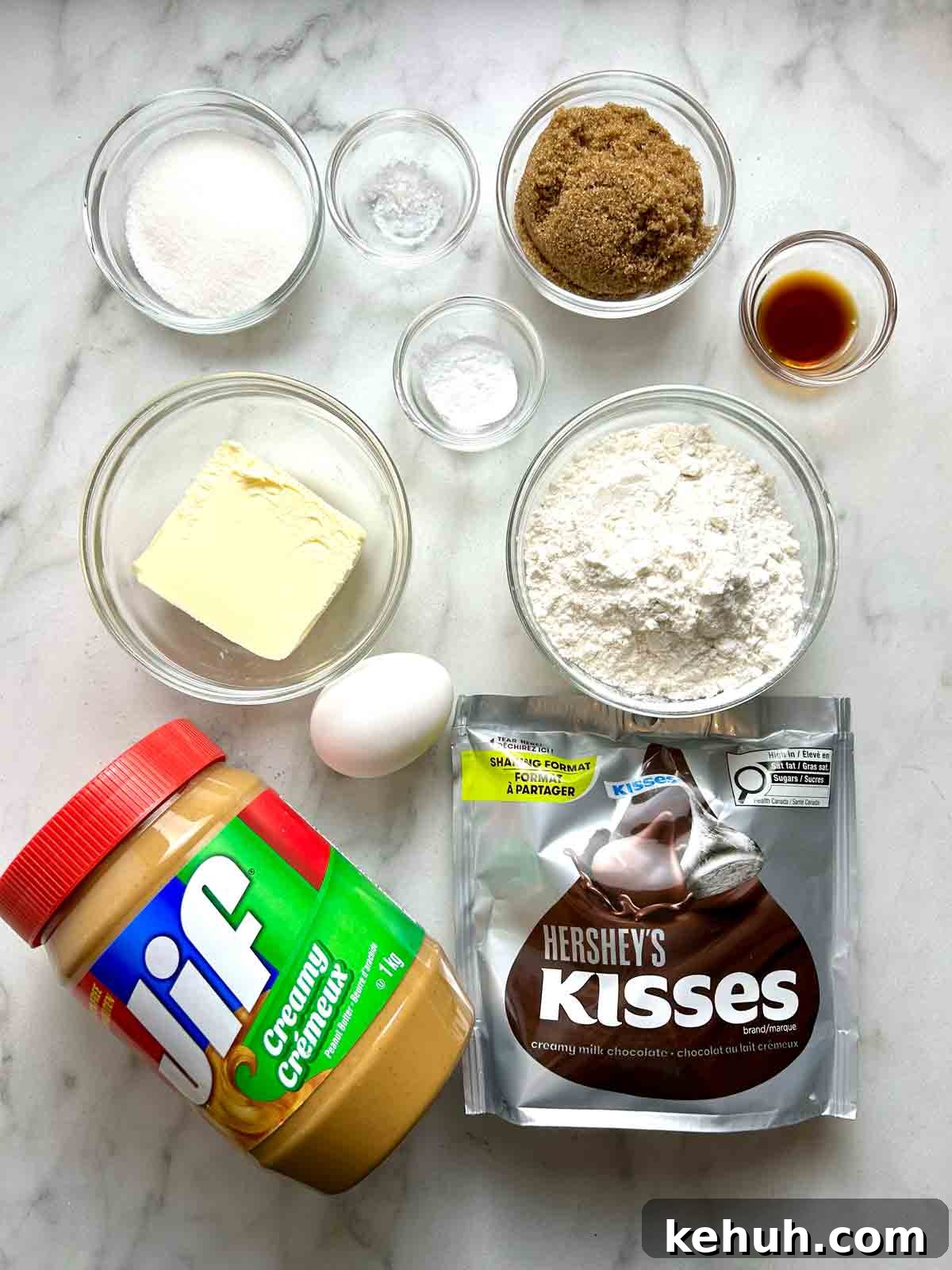 Classic Peanut Butter Blossom Cookies: Soft Chocolate Kiss Treats 3 ingredients prepped in bowls; jar of peanut butter and bag of Hershey's Kisses.